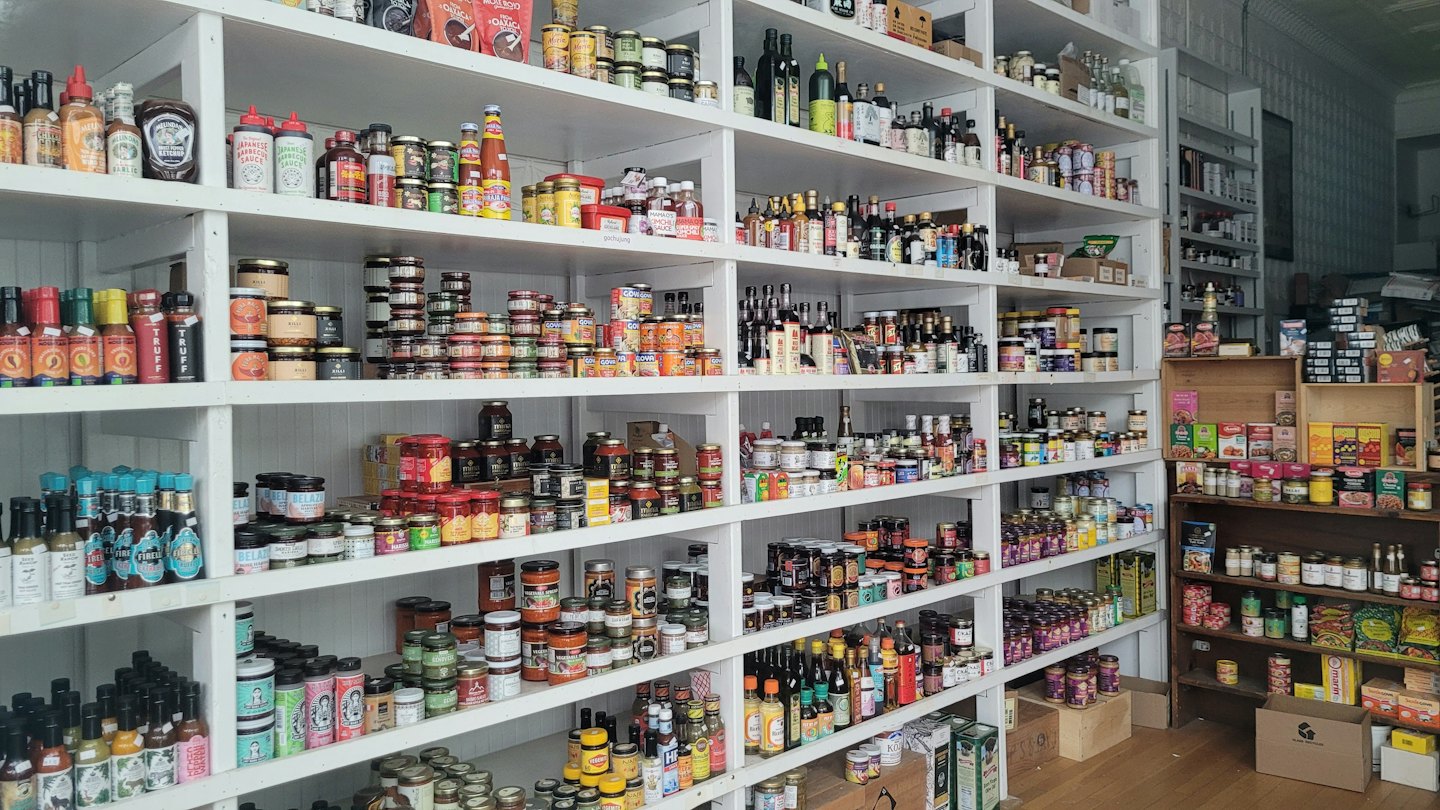Shelves packed with jars and bottles of food products.