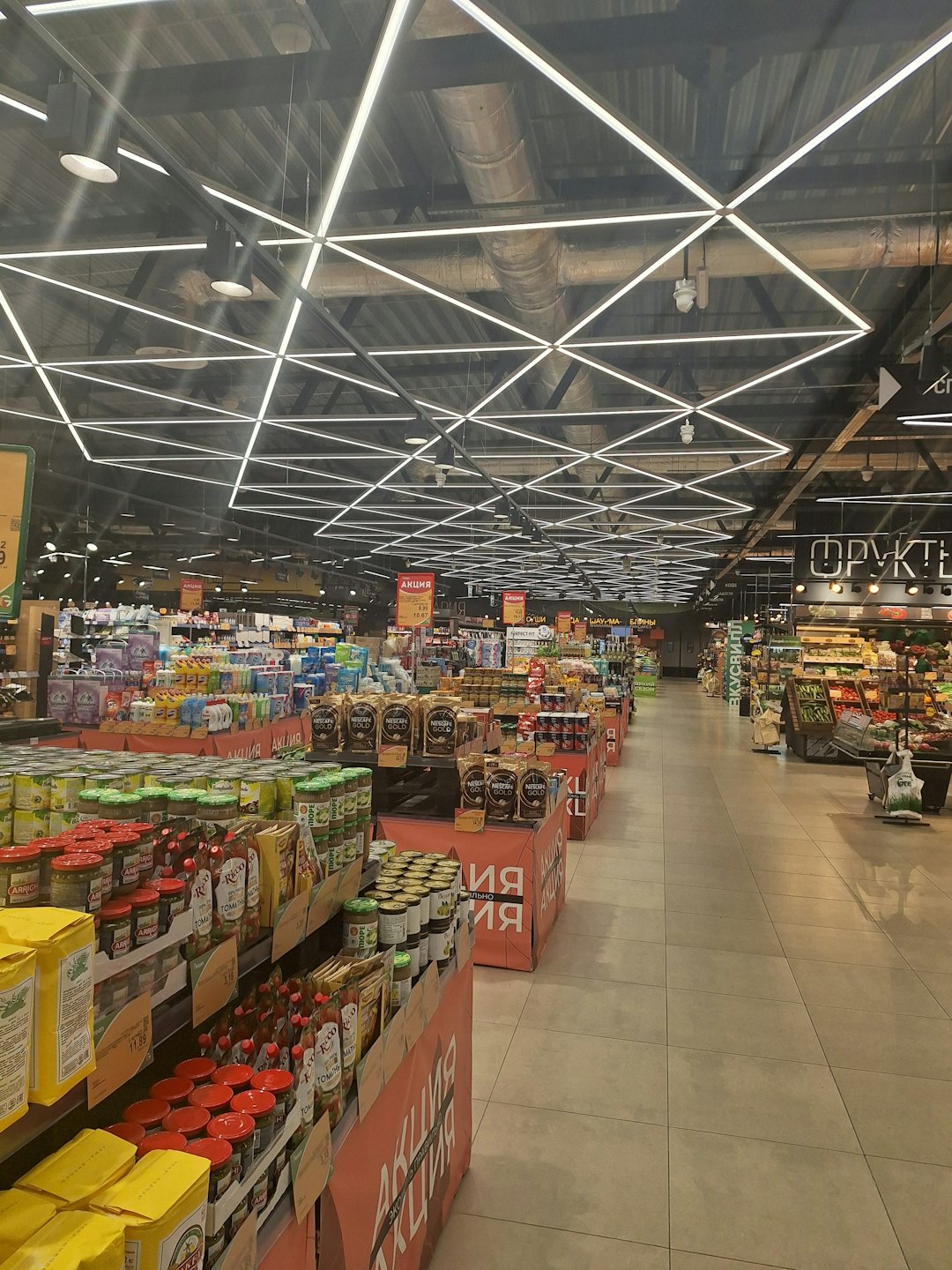 Neatly stocked grocery shelves inside a modern supermarket aisle.
